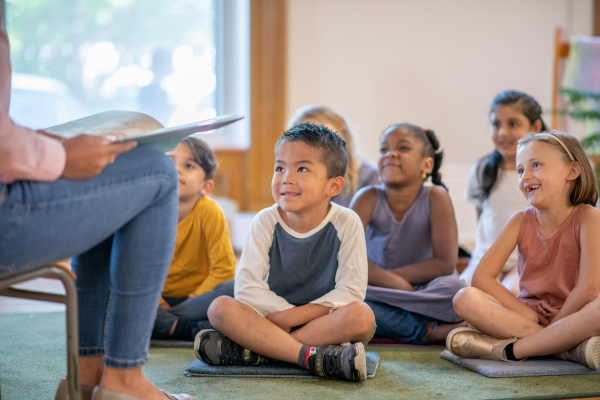 Students reading from book packs for schools 